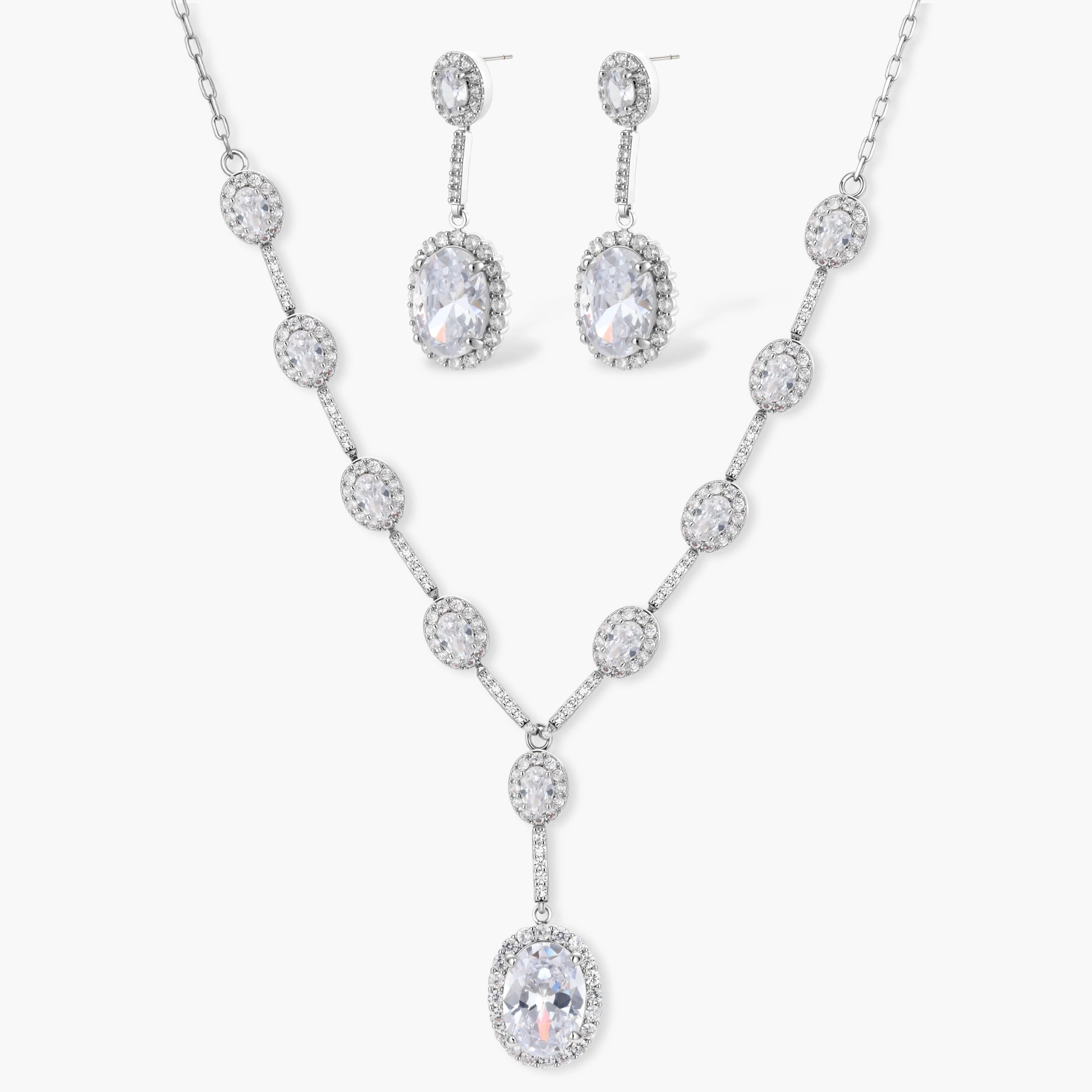 Elegant white gold plated jewelry set with oval cubic zirconia stones in halo settings, featuring Y-necklace and drop earrings.