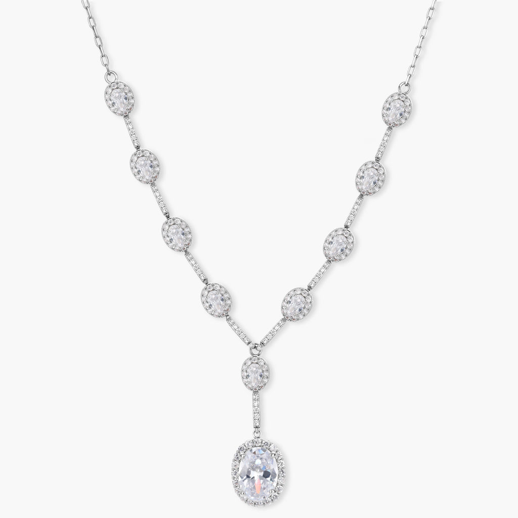 Elegant white gold plated jewelry set with oval cubic zirconia stones in halo settings, featuring Y-necklace and drop earrings.